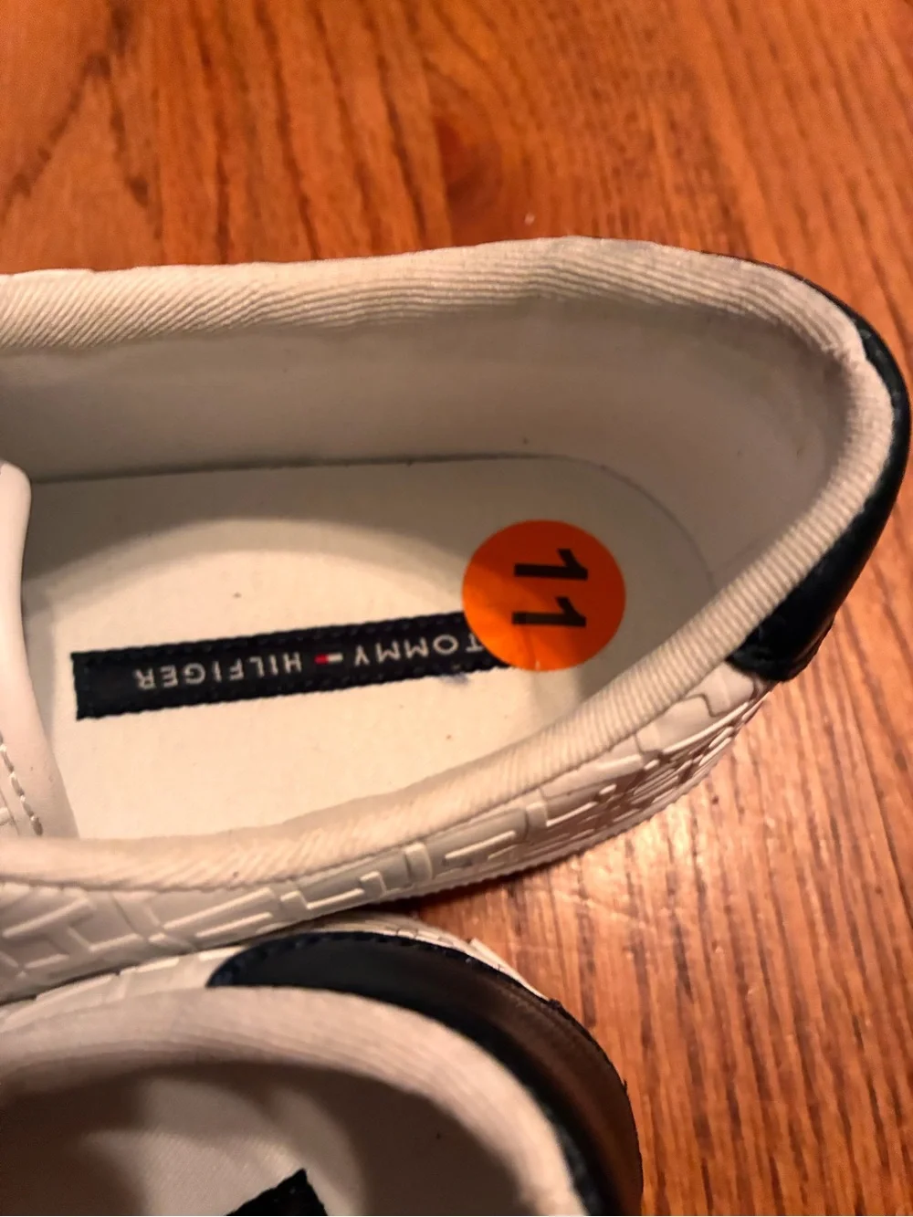 Tommy Hilfiger White Embossed Sneakers with Navy Heel and Red-White-Blue Stripe.